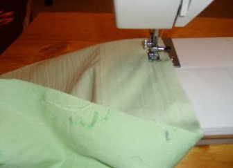 Sew the edges on a sewing machine. This can be done on the overlock, zigzag or hem the folded edges of the fabric.